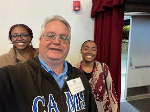 Thomas Norman with two students at a campus event